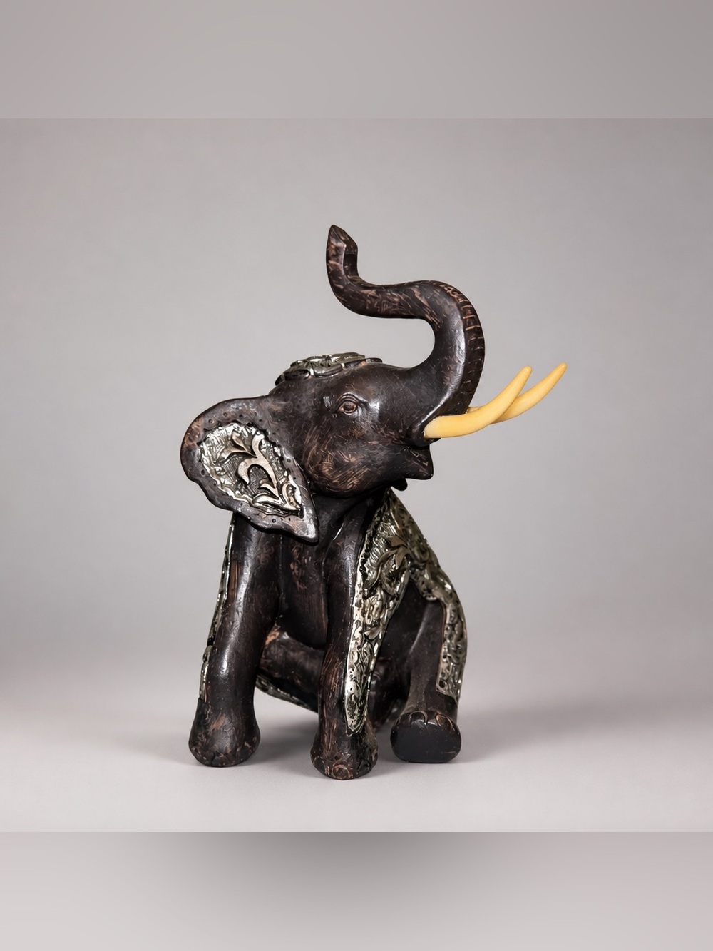 DecMode Eclectic Polystone Sitting Elephant Sculpture.